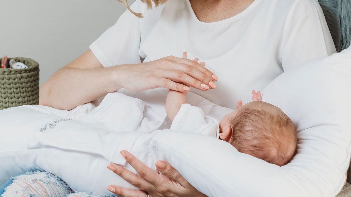 Why are newborns soothed by being contained and touched?